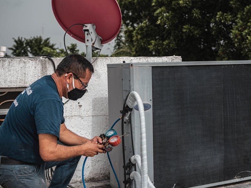 HVAC technician servicing a unit